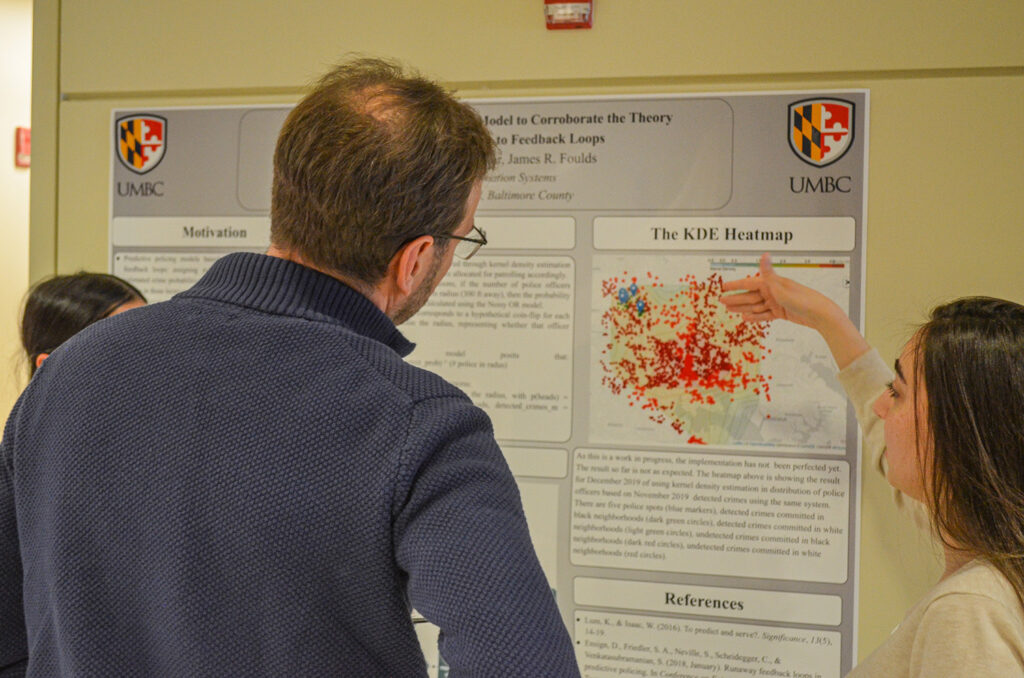 participants of poster presentations discussing their research 