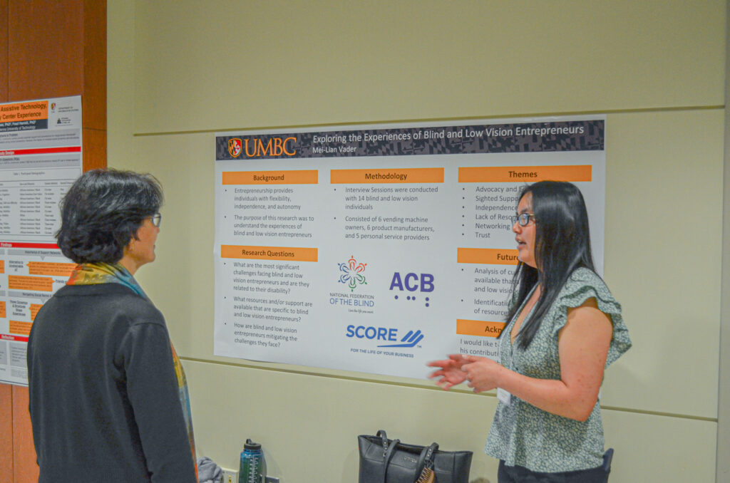 Event attendees discussing a research poster