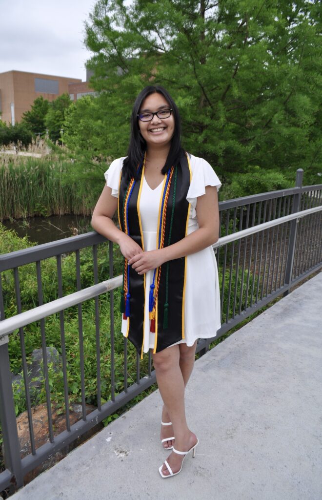Mei-Lian Vader posing for a photo on campus during commencement 