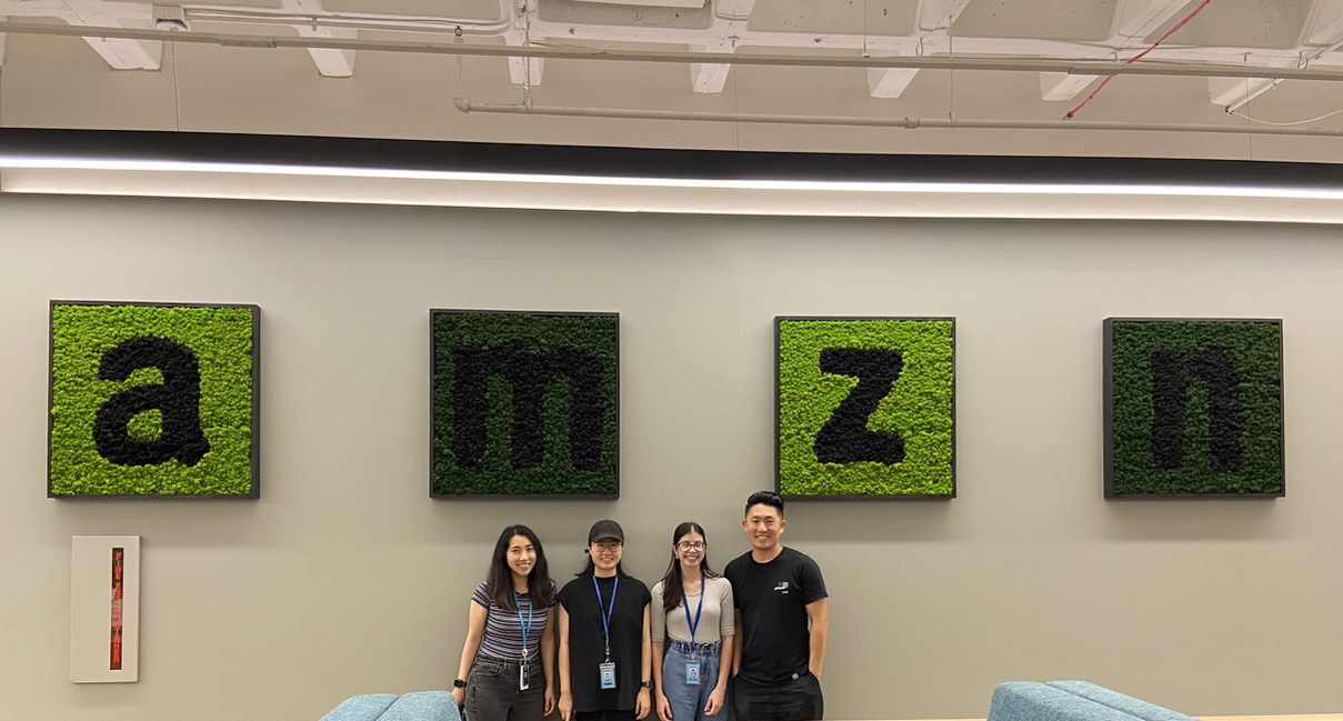 four individuals standing in a conference room at Amazon