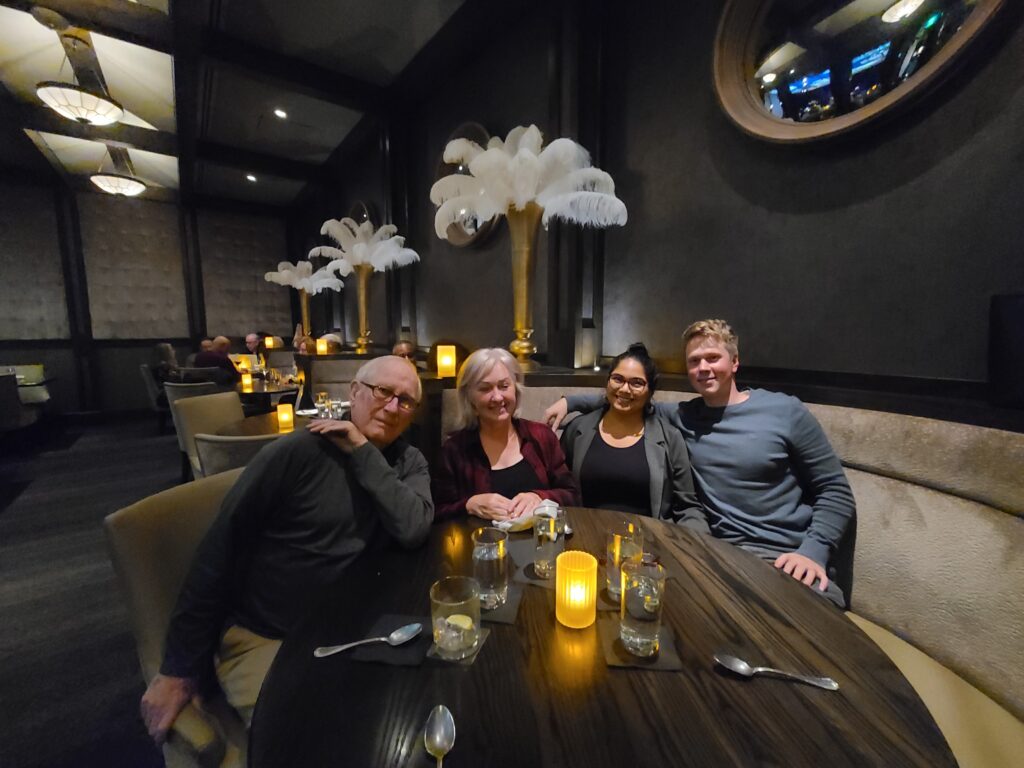 Karina, her husband Chris, and her in-laws enjoying dinner