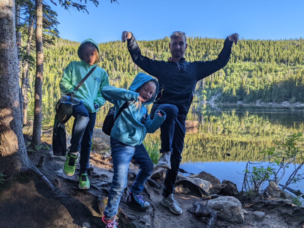 family posing for a photo near water