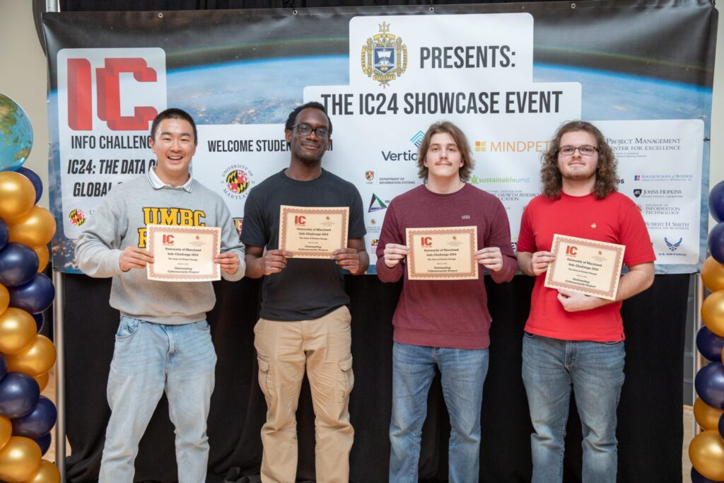 Leon Tang, Oluwatimilehin Olayinka, Christopher Humbert, and Dale Neumeister standing with their prizes after winning a competition