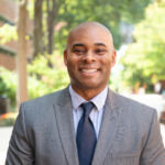 Edward Dillion headshot, standing outside on campus